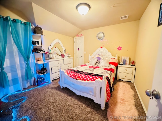 bedroom featuring dark colored carpet and vaulted ceiling