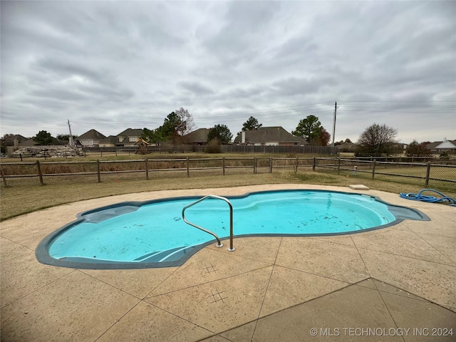 view of swimming pool with a patio area