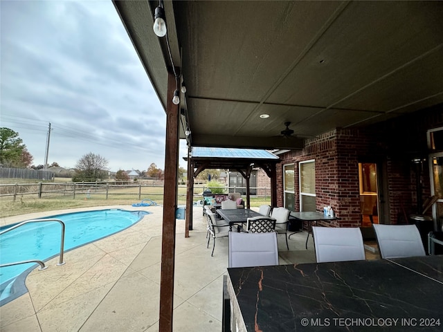 view of swimming pool with a gazebo, ceiling fan, and a patio area