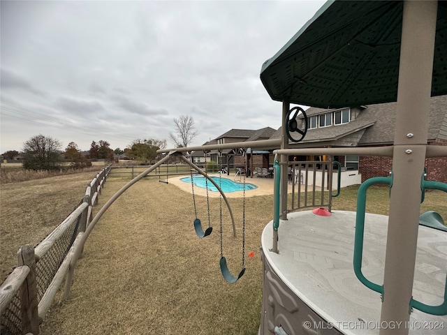 view of pool featuring a playground