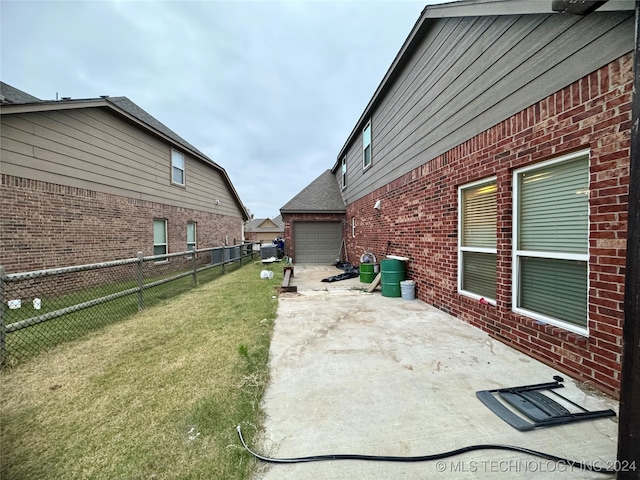 exterior space with a patio and a lawn