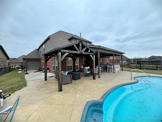 view of swimming pool with an outdoor living space and a patio area