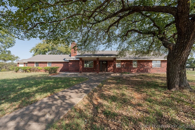 ranch-style home with a front lawn