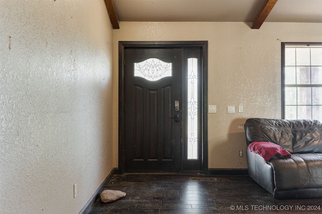 foyer featuring dark hardwood / wood-style floors and beam ceiling