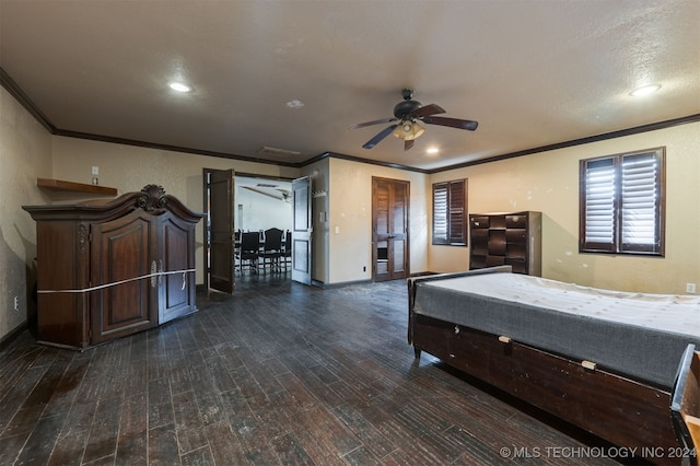 unfurnished bedroom with ceiling fan, dark hardwood / wood-style flooring, ornamental molding, and a textured ceiling