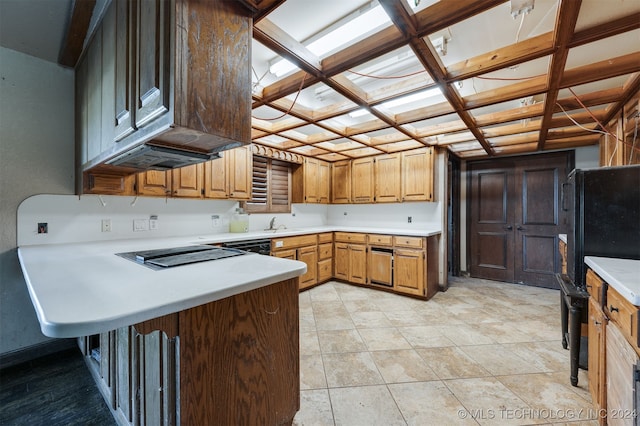 kitchen featuring kitchen peninsula, sink, coffered ceiling, and black appliances