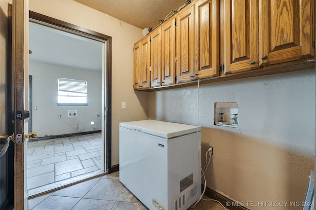 laundry room featuring cabinets and washer hookup