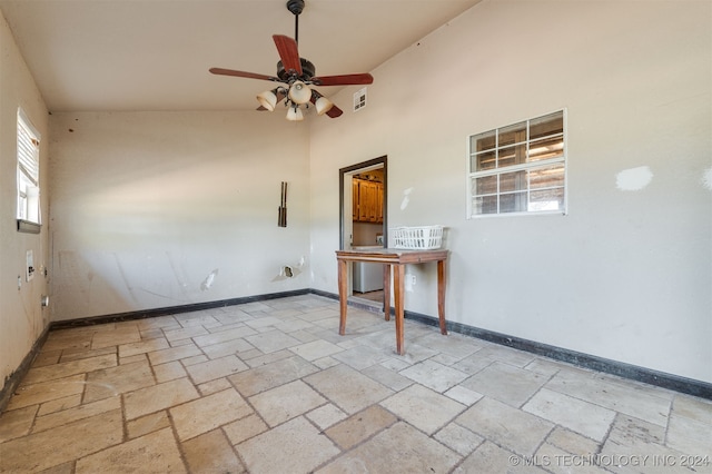 empty room featuring ceiling fan and high vaulted ceiling