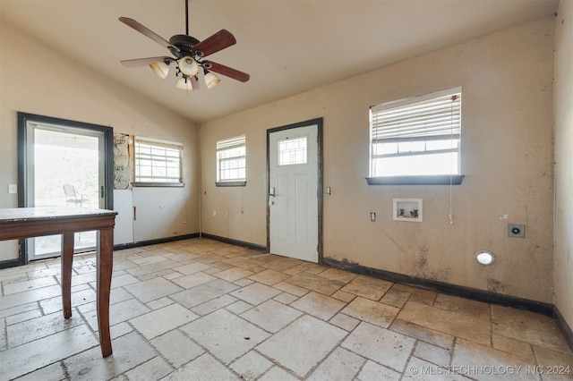 foyer entrance with ceiling fan and lofted ceiling