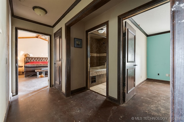 hall with concrete flooring and crown molding