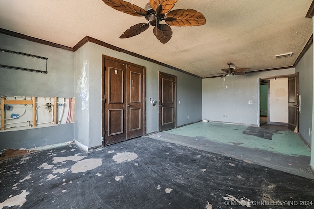 interior space featuring ceiling fan, a textured ceiling, and ornamental molding