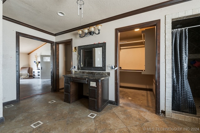 interior space featuring ornamental molding and a textured ceiling