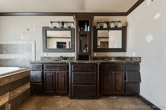 bathroom featuring tile patterned floors, a textured ceiling, vanity, crown molding, and a relaxing tiled tub