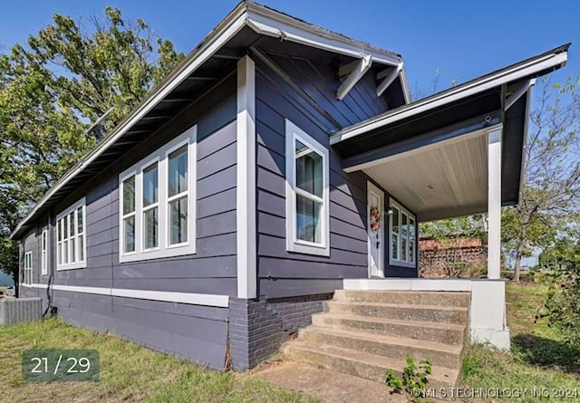 view of side of home with a porch