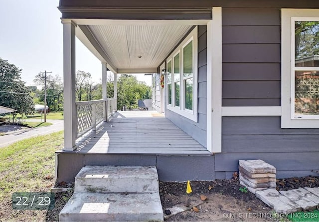 wooden terrace featuring covered porch