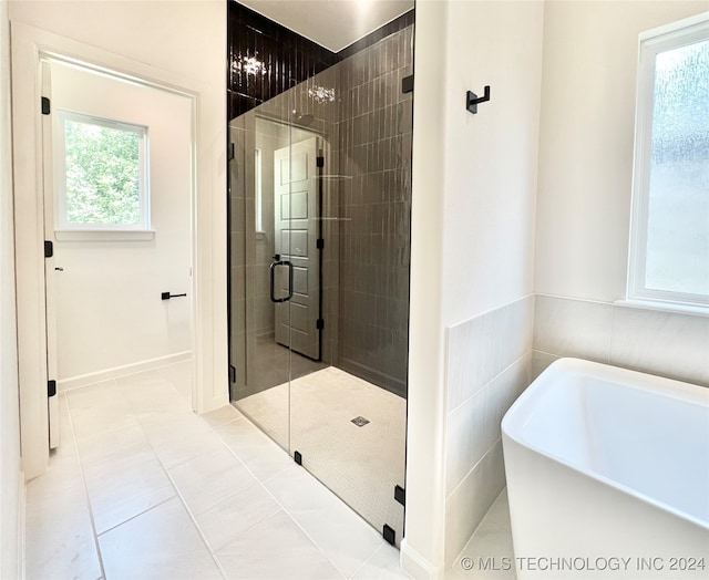 bathroom featuring separate shower and tub and tile patterned floors