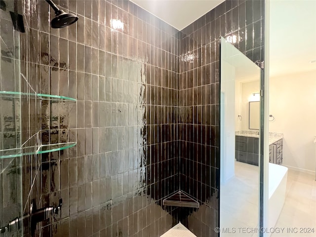 bathroom with vanity and tiled shower