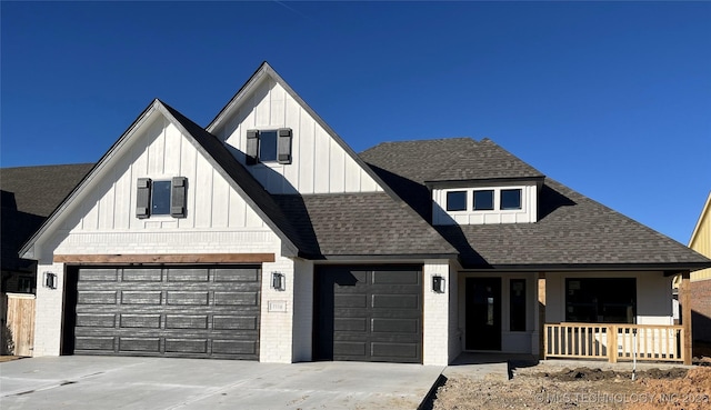 modern farmhouse featuring a garage and covered porch