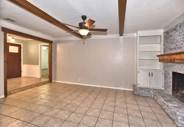 unfurnished living room featuring ceiling fan, light tile patterned flooring, a textured ceiling, and a brick fireplace