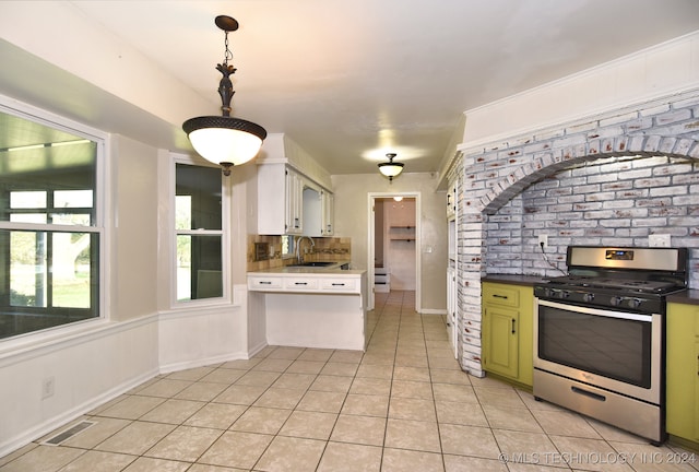 kitchen featuring stainless steel range, sink, light tile patterned floors, green cabinets, and white cabinets