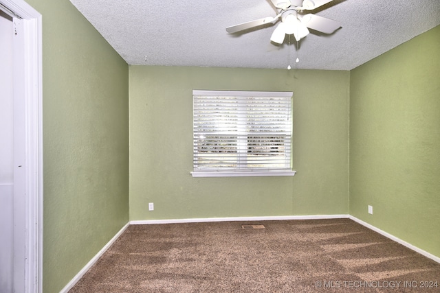 empty room featuring carpet flooring, ceiling fan, and a textured ceiling