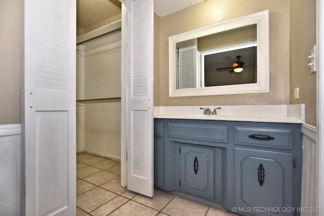 bathroom with vanity, a textured ceiling, tile patterned floors, and ceiling fan