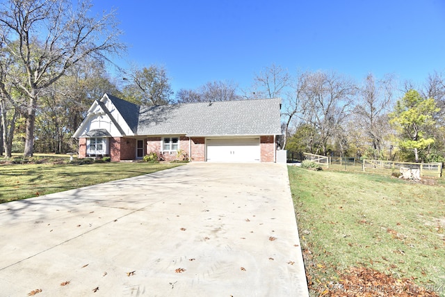 view of front of house featuring a front lawn and a garage