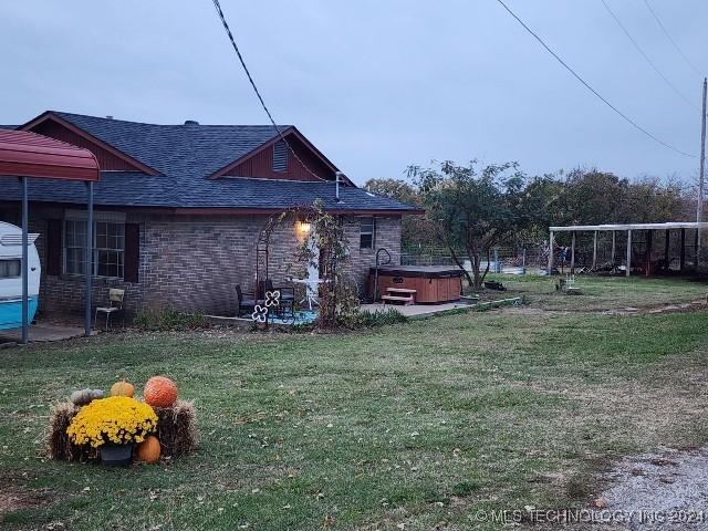 view of yard featuring a patio and a hot tub