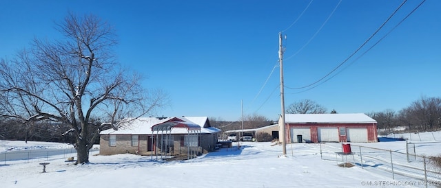 view of front of house featuring a garage and an outdoor structure