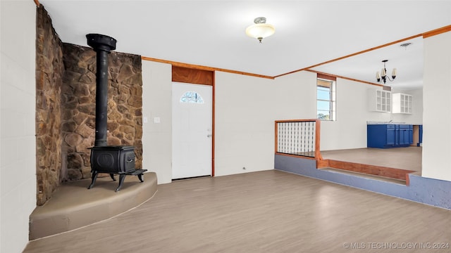 unfurnished living room featuring hardwood / wood-style flooring and a wood stove