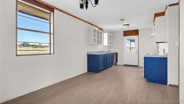 kitchen with blue cabinetry, sink, white cabinets, and light hardwood / wood-style floors