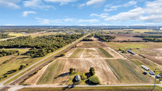 birds eye view of property with a rural view