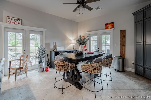 dining space with french doors, ceiling fan, and light tile patterned flooring