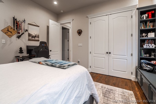 bedroom featuring dark hardwood / wood-style floors and a closet