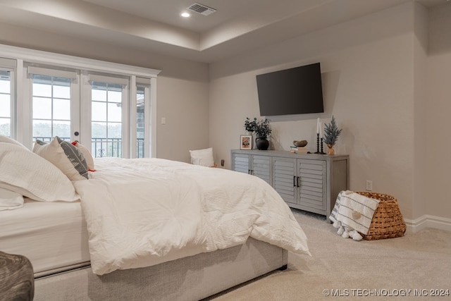 bedroom with access to outside, french doors, and light colored carpet