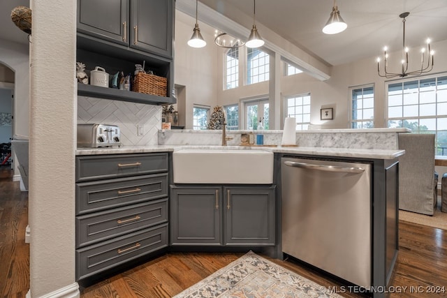 kitchen featuring stainless steel dishwasher, dark hardwood / wood-style flooring, sink, and tasteful backsplash