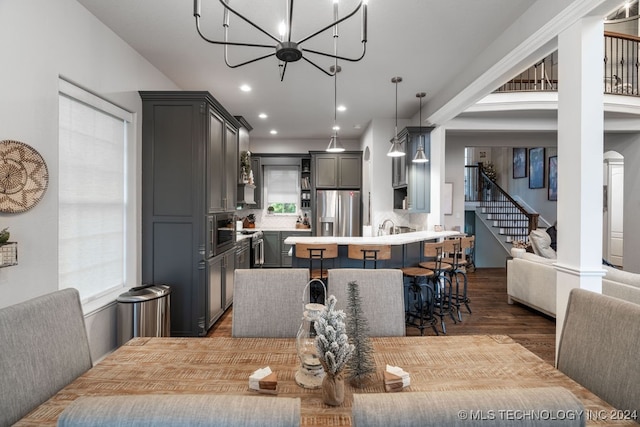 dining space with dark hardwood / wood-style flooring and a chandelier