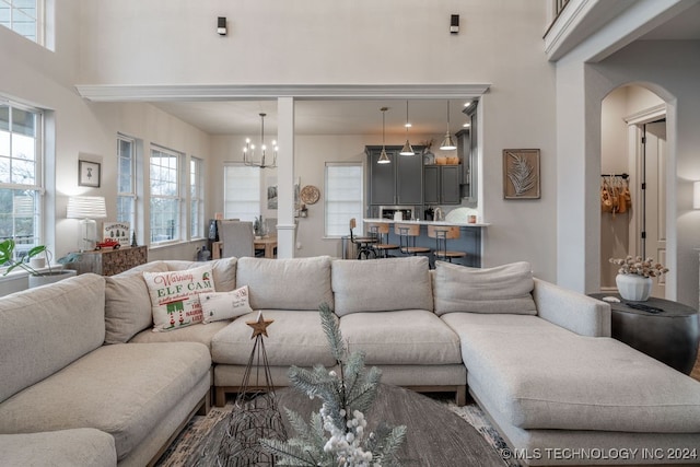 living room featuring a high ceiling and a notable chandelier