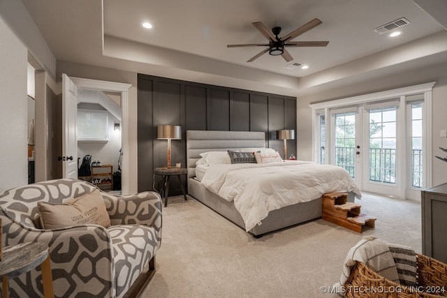 bedroom featuring french doors, access to outside, ceiling fan, and light colored carpet