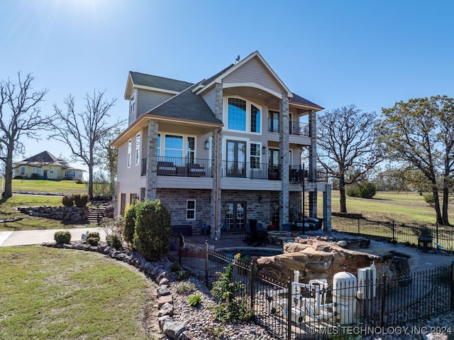 exterior space featuring a balcony and french doors