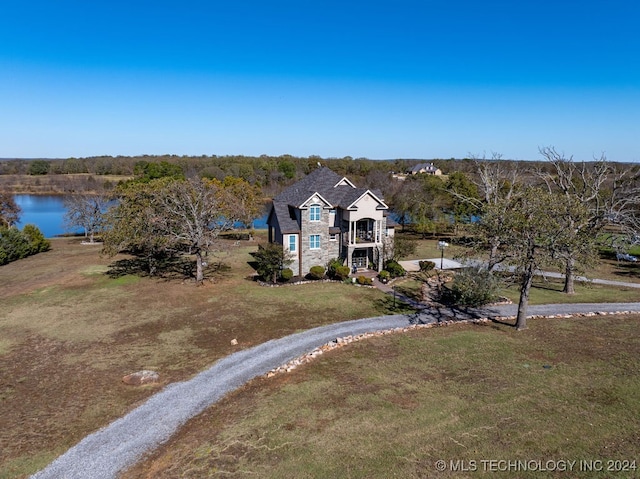 view of front of house featuring a water view and a front lawn