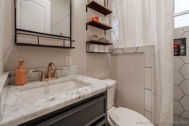 bathroom featuring vanity and toilet