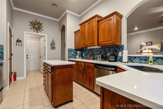 kitchen featuring stainless steel dishwasher, a kitchen island, light tile patterned floors, and crown molding