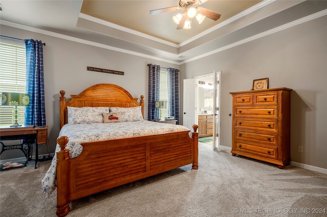 bedroom featuring ceiling fan, multiple windows, and ensuite bath