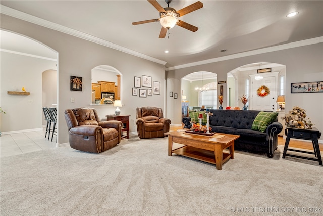 living room with ceiling fan with notable chandelier, crown molding, and light carpet