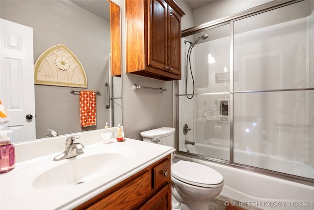 full bathroom featuring toilet, vanity, and combined bath / shower with glass door