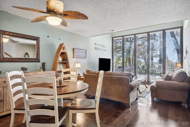 dining area featuring a textured ceiling, dark hardwood / wood-style floors, and ceiling fan