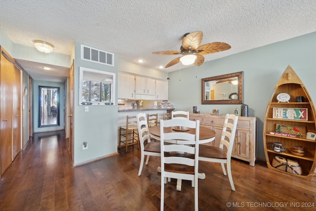 dining room featuring ceiling fan, dark hardwood / wood-style flooring, and a textured ceiling