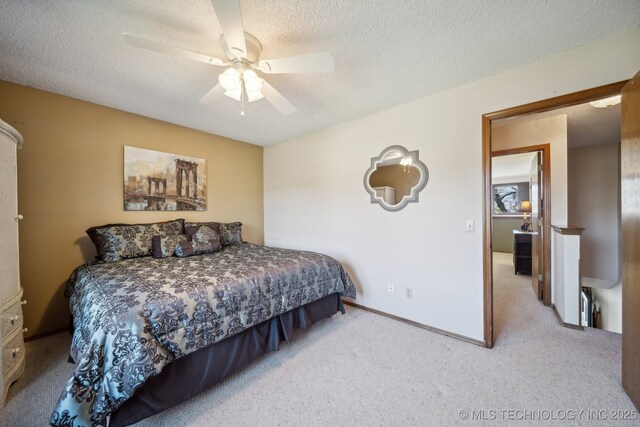 carpeted bedroom with ceiling fan and a textured ceiling