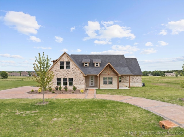684 Chateau Bnd, Ardmore, OK 73401 - view of front of home with a front yard, a shingled roof, and brick siding